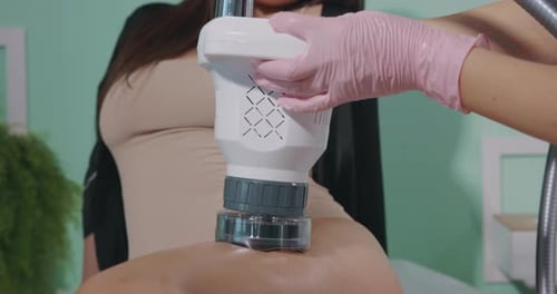 Health Professional Using Medical Device on Person's Back