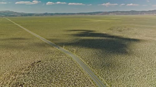 Car driving along a twisting road in the Valley