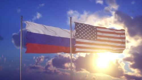 Russian and American Flags Waving Together at Golden Sunset