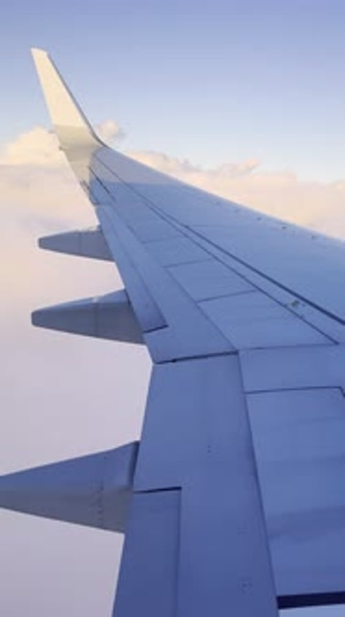Airplane Wing Panoramic Shot with Sunlight Above Fluffy Cloudscape Sky Horizon