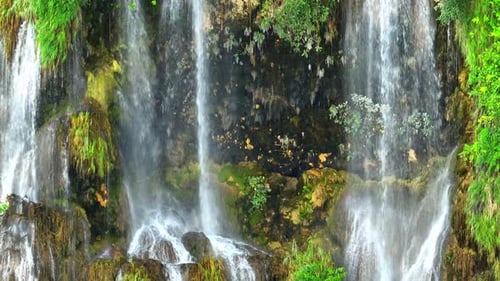 Beautiful waterfall in a tropical forest by aerial view from a drone.
