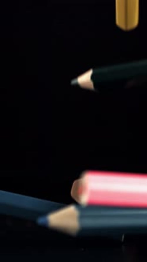 Colored Pencils Falling on a Table on a Black Background Filmed on a Highspeed Camera at 1000 Fps
