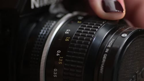Close Up of Woman Adjusting a Camera Lens