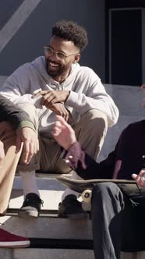 People, laughing and relax at skatepark with conversation, funny story or bonding together