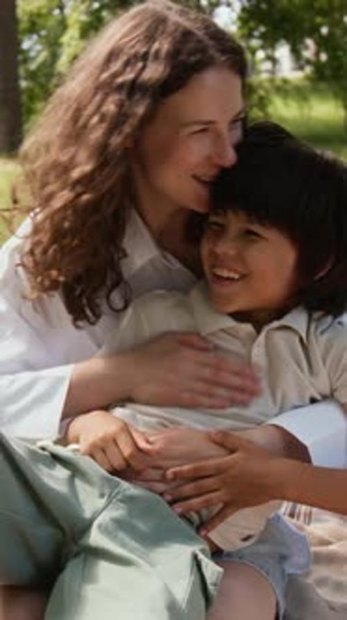 Woman and Child Embrace in Green Park