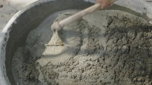 Mixing Cement with a Hoe in a Tub