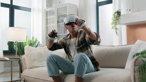 Young Adult Wearing VR Headset Playing Video Game