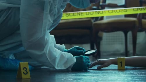 Crime Scene Investigator Examines Body with Magnifying Glass