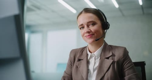 Smiling Woman with Headset in Modern Office
