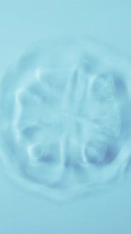Natural Water Splashing Rings and Ripple Top View Drop of Cosmetic Essence Serum Falling in Slow