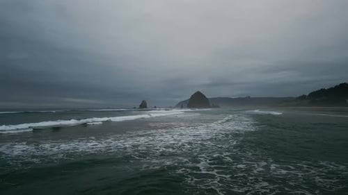 Wide Aerial Shot of Haystack Rock Beach in Coastal Town Cannon Beach Oregon