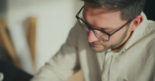 Businessman Wearing Eyeglasses and Working at Office