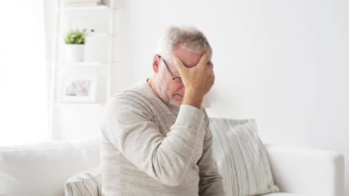 Senior Man Experiencing Headache, Stress, and Discomfort