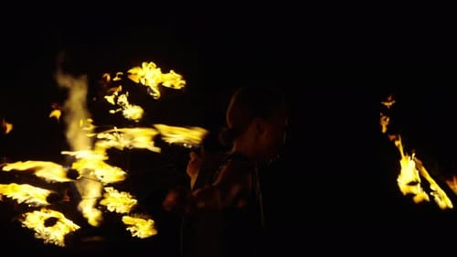Woman Performs Fire Dance in the Night