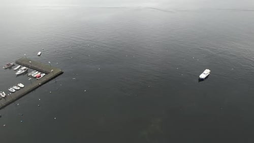 Boats Docked in Quiet Harbor on Cloudy Day