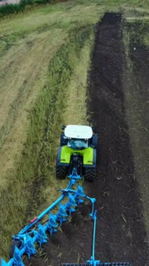 Tractor Plows The Field. Tractor with cultivator handles field before planting