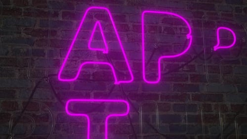 Glowing Neon Happy Birthday Sign Animation on Brick Wall