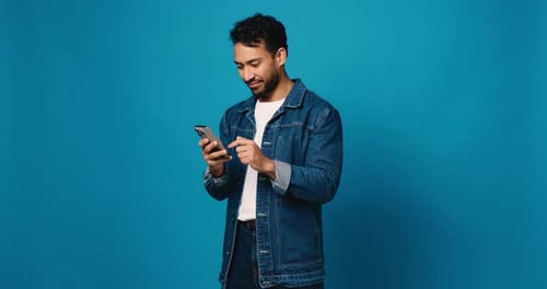 Scroll, phone and smile with man in studio for social media, text message and communication