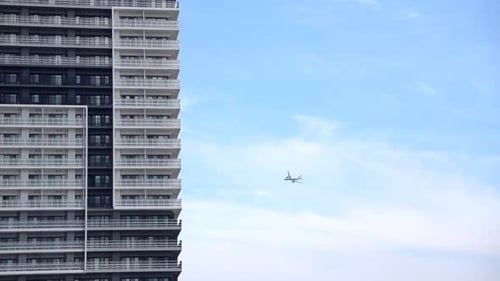 Airplane Passing by a Building