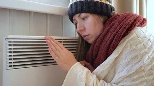 Young Frozen Woman Wearing a Sweater Shaking and Freezing for Winter Cold with Shock Expression on