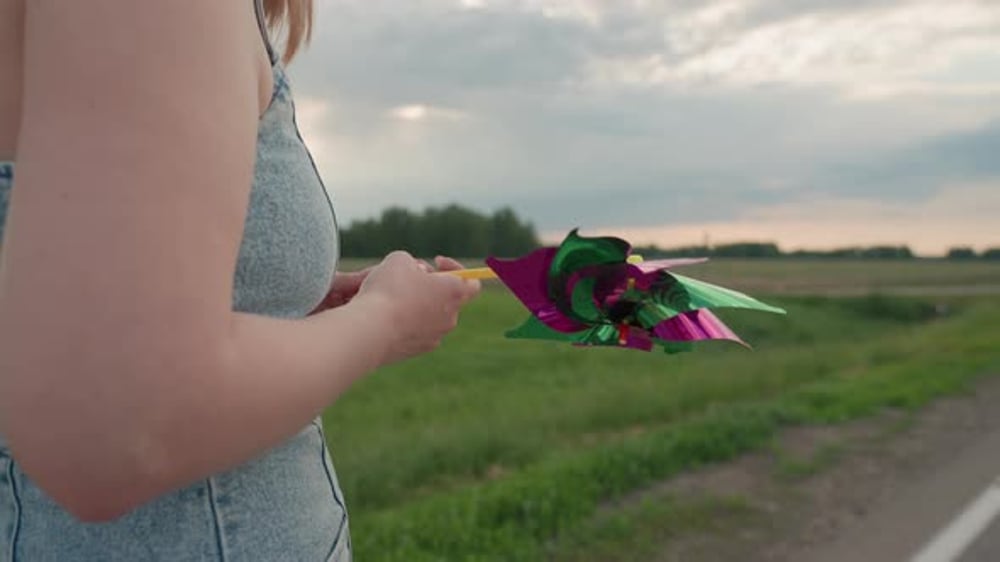 Close Up Rear View Woman Rotating Pinwheel on Rural Road, People Stock ...