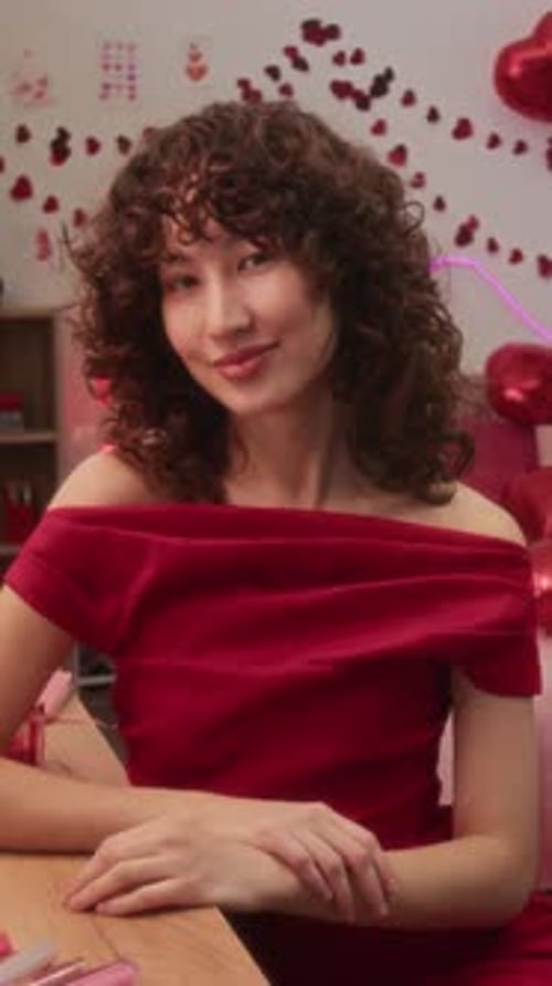 Vertical Portrait of Joyful Young Woman in Red Dress in Holiday Room