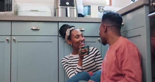 Happy Couple Chatting with Coffee on Kitchen Floor