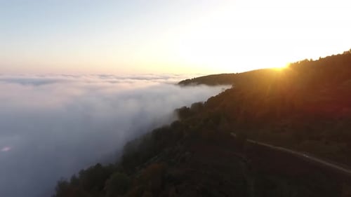 Aerial View of Mountains at Sunrise Above Clouds