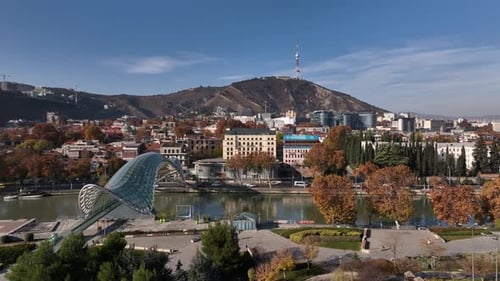 Aerial view of Tbilisi city central park and Bridge of Peace. Beautiful cityscape of old Tbilisi