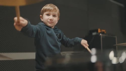 Young Talented Boy Playing Drums in Music Studio