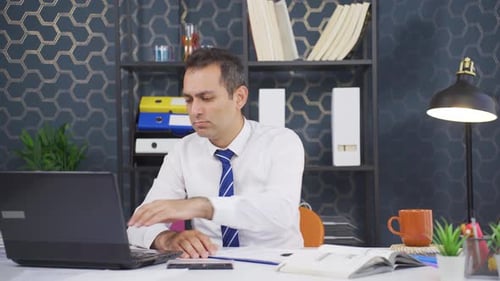 Man Works at Desk in an Office