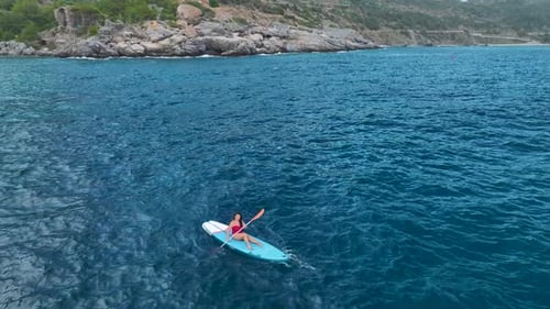 Aerial View Beautiful Paddleboarding Journey Through a Mediterranean Lagoon