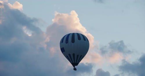 Hot air balloons with fire light flying in the blue sky in Cappadocia, Turkey
