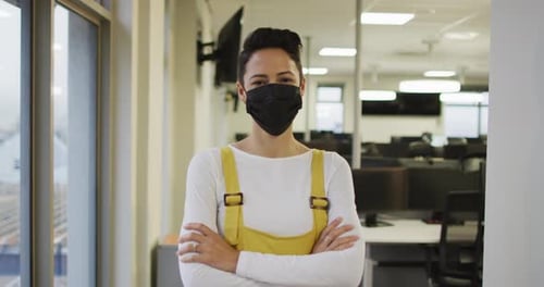 Smiling Woman with Mask in Modern Office