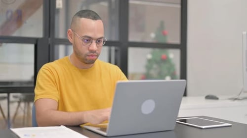 Man Works on Laptop, then Points No
