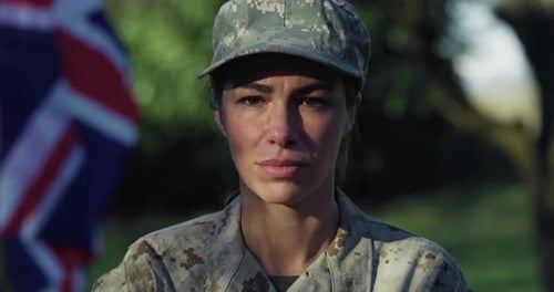 Close Up Slow Motion Portrait of Young Female Patriotic Soldier Standing in Front of the British