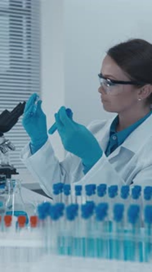 Woman Scientist with Test Tubes in Laboratory