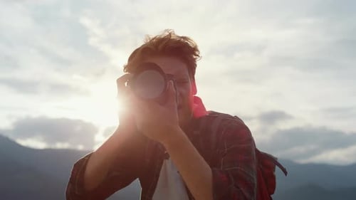 Adventurous Man with Camera Outdoors Exploring Nature