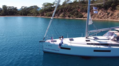 Attractive Woman Sits On Boat And Takes Pictures