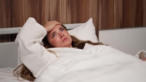 Close Up in Modern Clinic in a Bright VIP Room Lies Young Girl in a White Coat with a Cold Medical