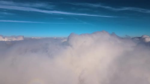 Aerial View From High Altitude of Earth Covered with White Puffy Cumulus Clouds on Sunny Day