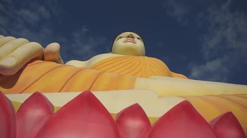 Upward moving shot of very large buddha statue