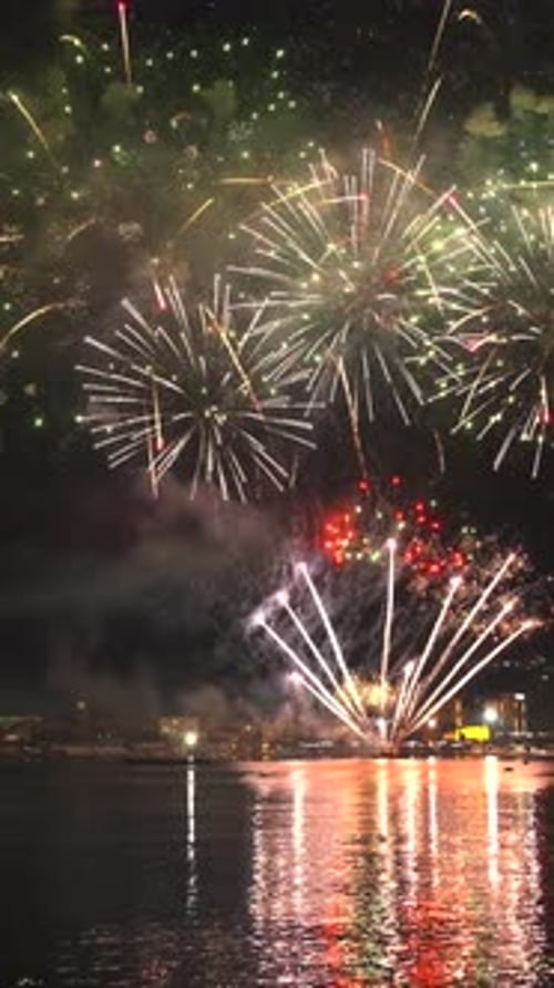 Fireworks with colorful lights over sea