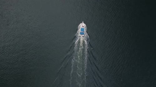 Motorboat Floats on Blue Water TopDown View