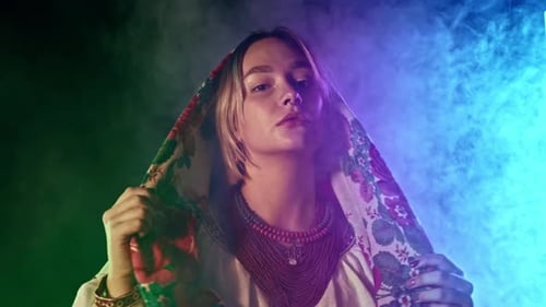 Young Woman with Headscarf Posing in Moody Lighting