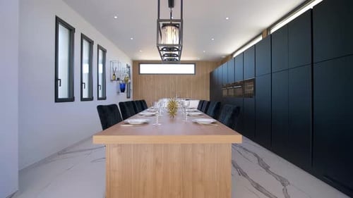Slow dolly shot of a prepared dining table with glasses and cutlery