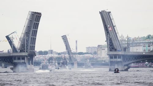 A Lot of Warships Goes Along the Neva River Under Open Bridges at the Time of the Rehearsal of the