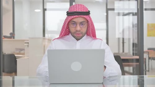 Man Receives Bad News on Laptop in Office