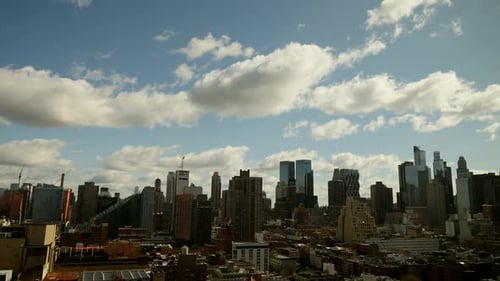 time lapse of clouds moving over city skyline. urban background scenery