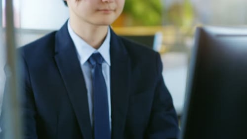 Young Man Working at Computer in Modern Office